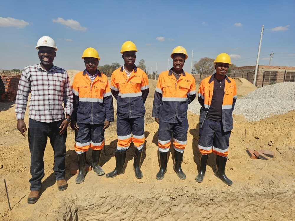 The Champs Construction team in hard hats and safety overalls on site