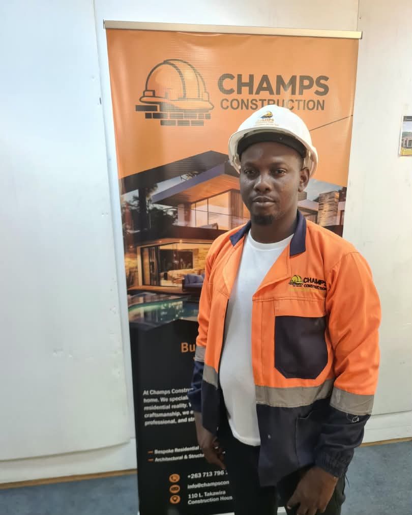 Mr R. Masiya in a Champs hard hat and safety jacket